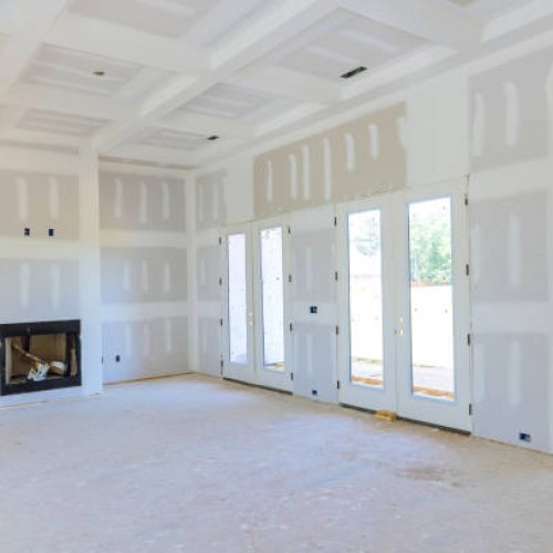 Plastering drywall in preparation for painting in newly constructed house Plastering drywall in preparation for painting in newly constructed house