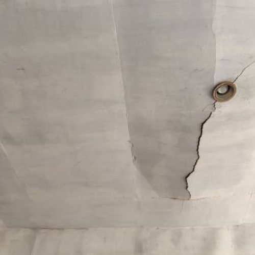 Portrait of the lamp on the cracked ceiling of the house Portrait of the lamp on the cracked ceiling of the house
